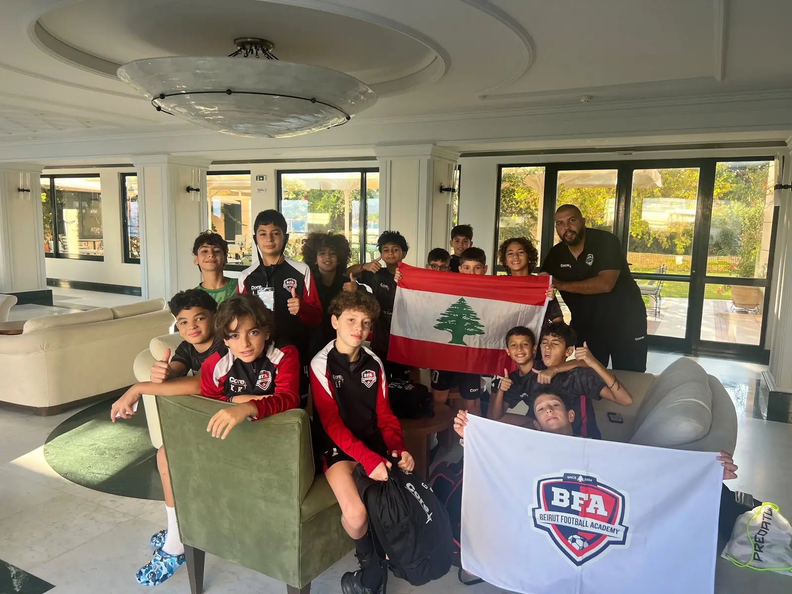 BFA U12 boys in Athens with the Lebanese flag and the BFA flag
